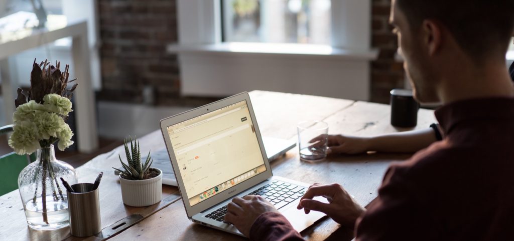 Man working on computer with someone